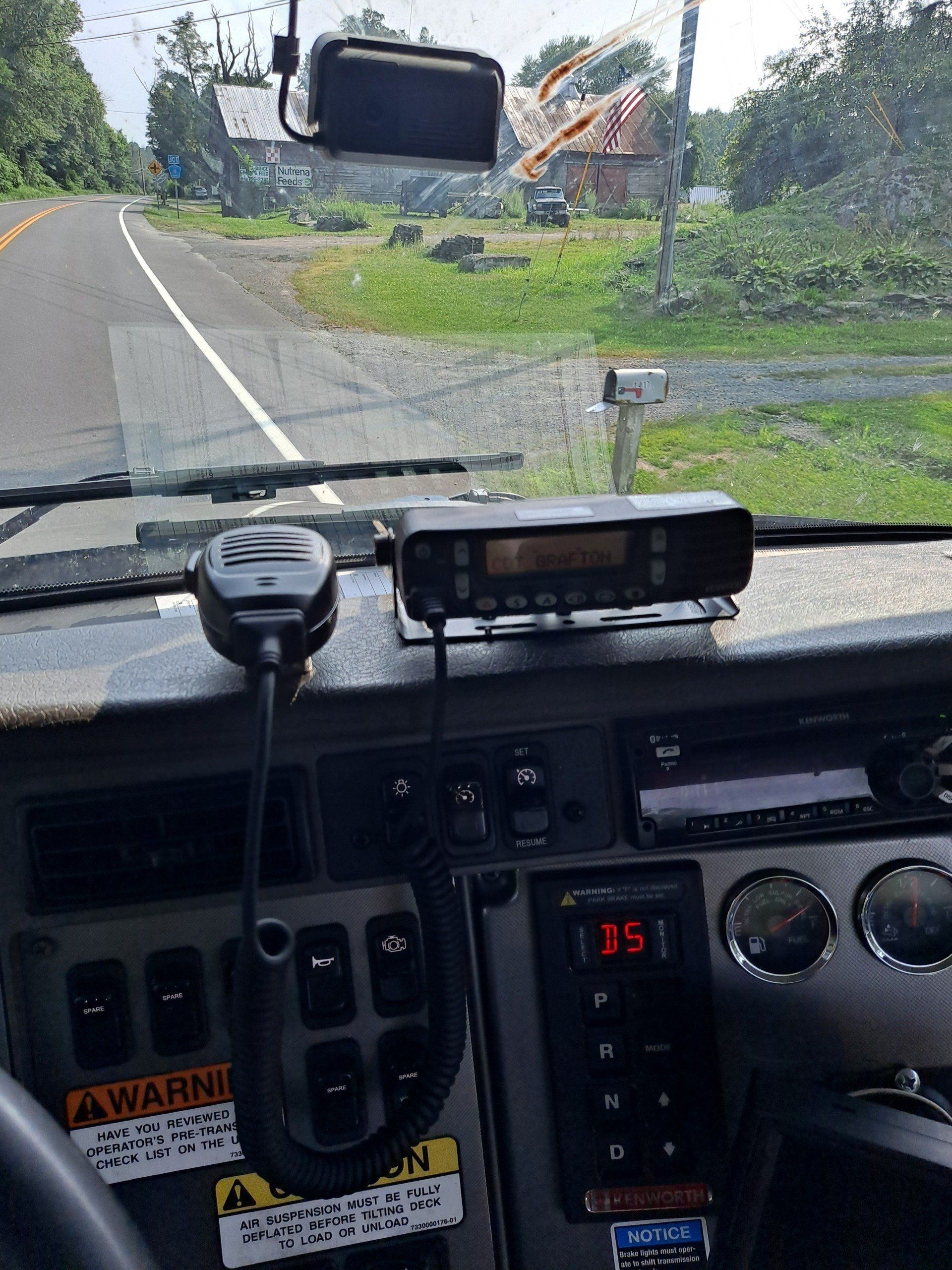 A dashboard of a truck with a warning sign on it.