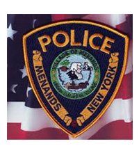 A police patch is sitting on top of an american flag.