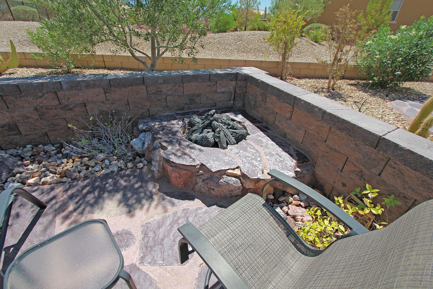 There is a fire pit in the middle of the patio.