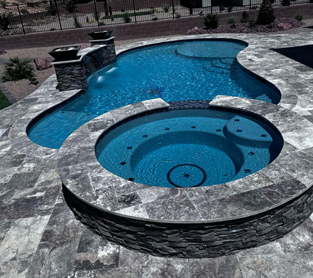 A large swimming pool with a hot tub in the middle