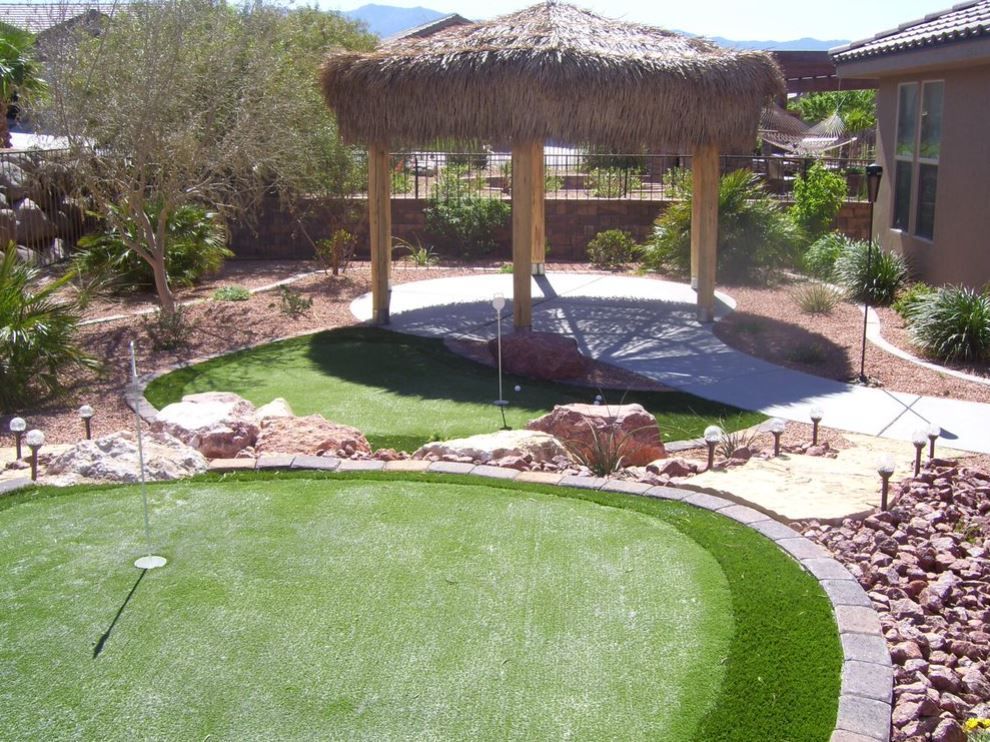 A putting green with a gazebo in the background