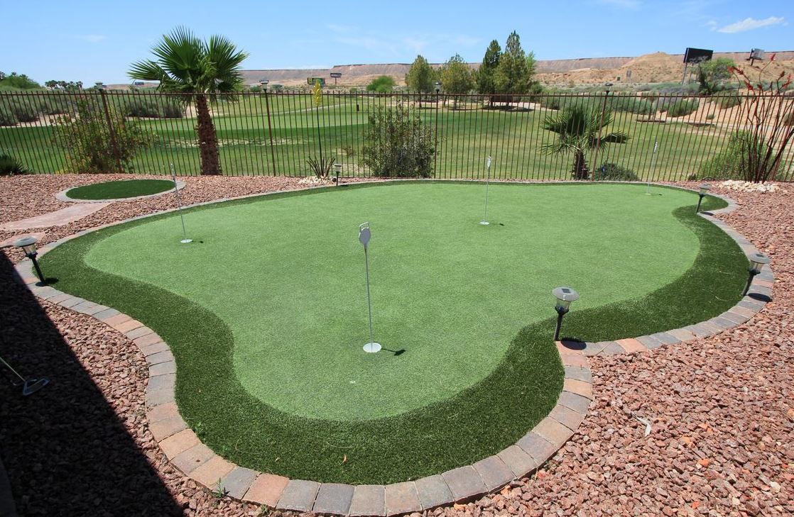 A putting green with a view of a golf course