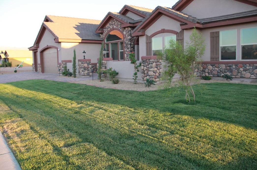 A large house with a lush green lawn in front of it