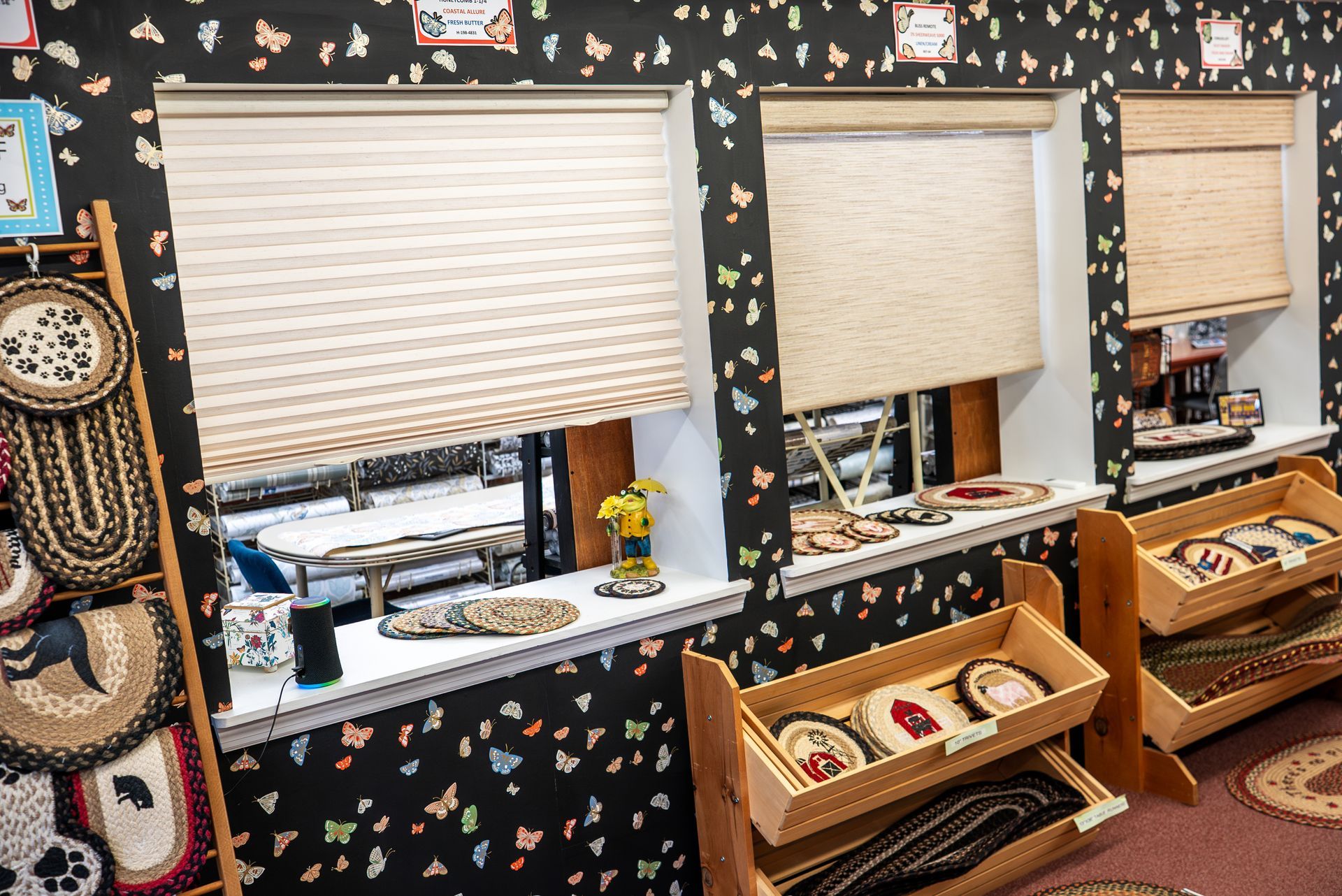 A woman is holding a rug in a room.