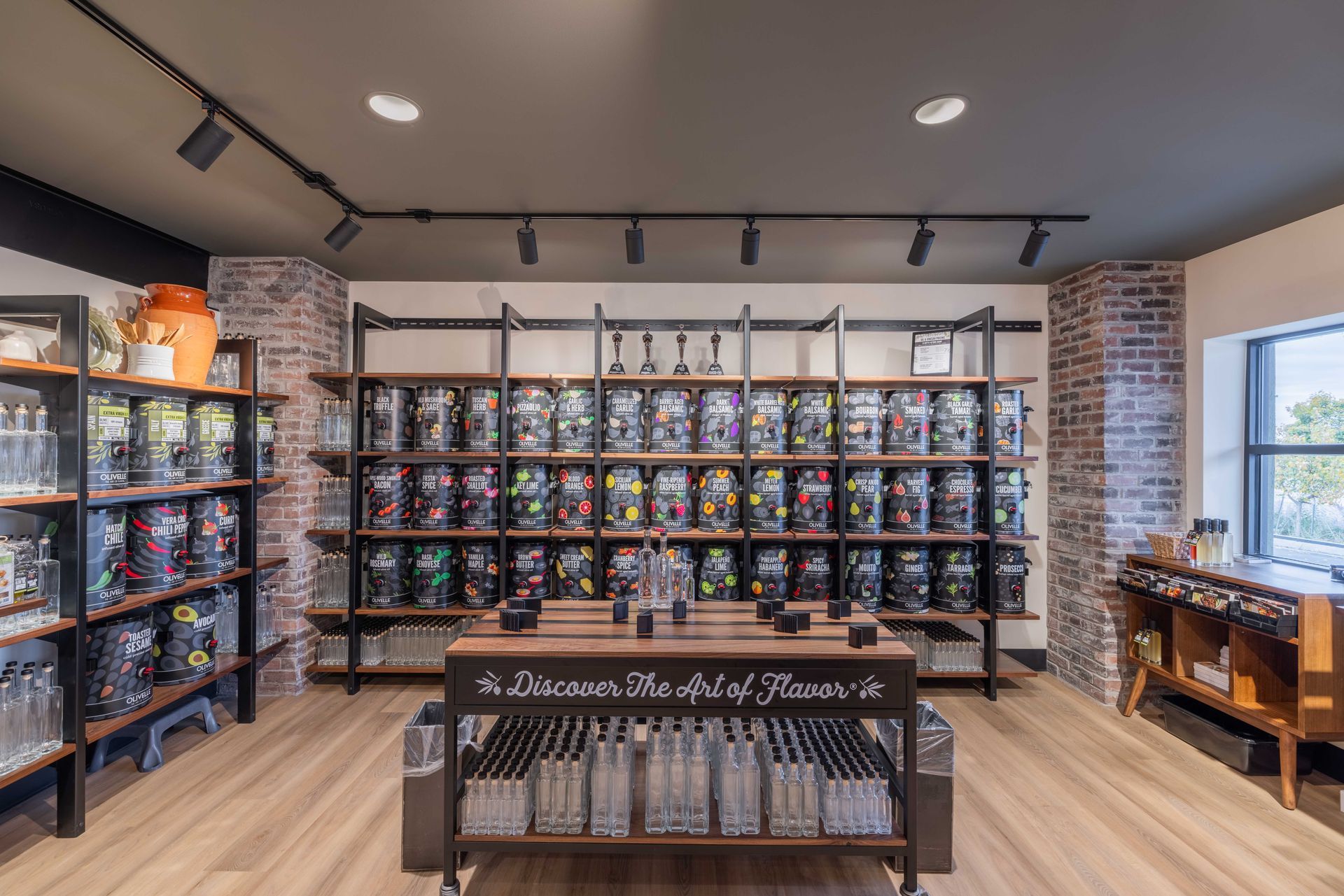 Toy store aisle with shelves of colorful boxed toys and a central display table under track lighting
