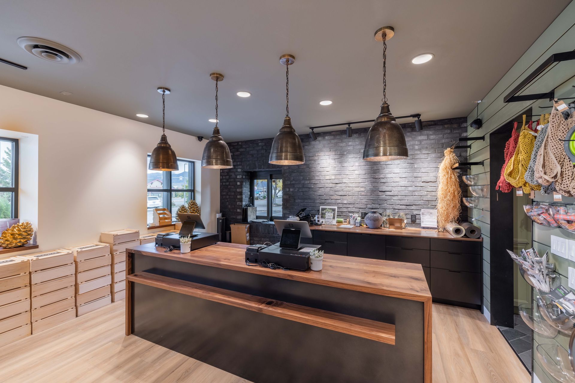 Modern reception area with brick wall, wood desk, pendant lights, and seating area