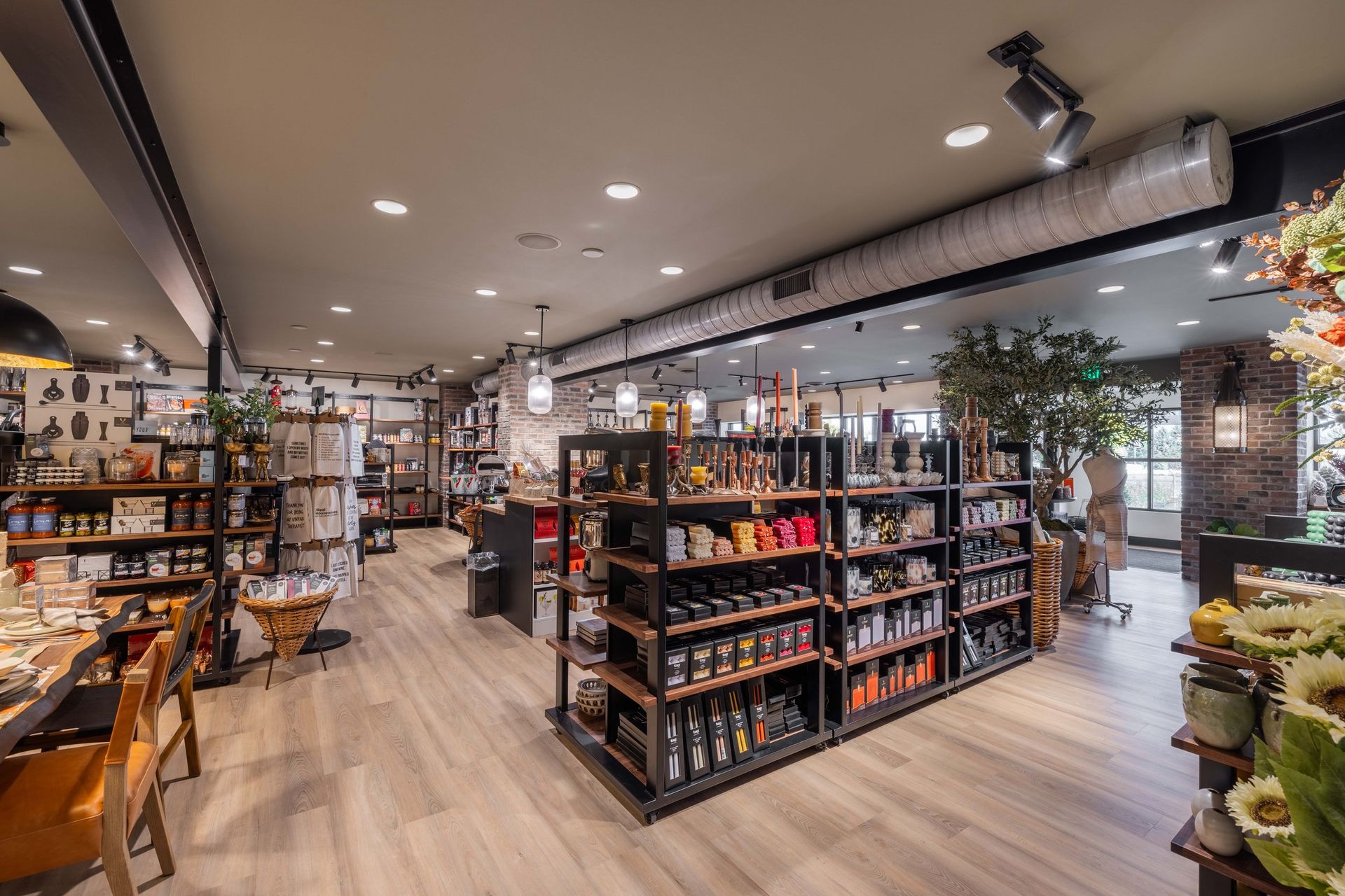 An inviting home decor shop interior featuring wooden shelving units filled with various products and decorative items.