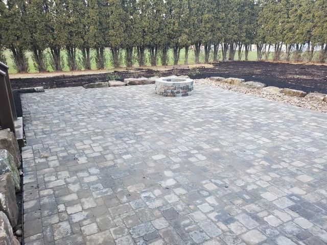 There is a fire pit in the middle of the patio.