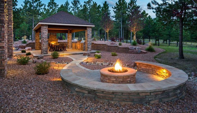 There is a fire pit in the middle of the yard.