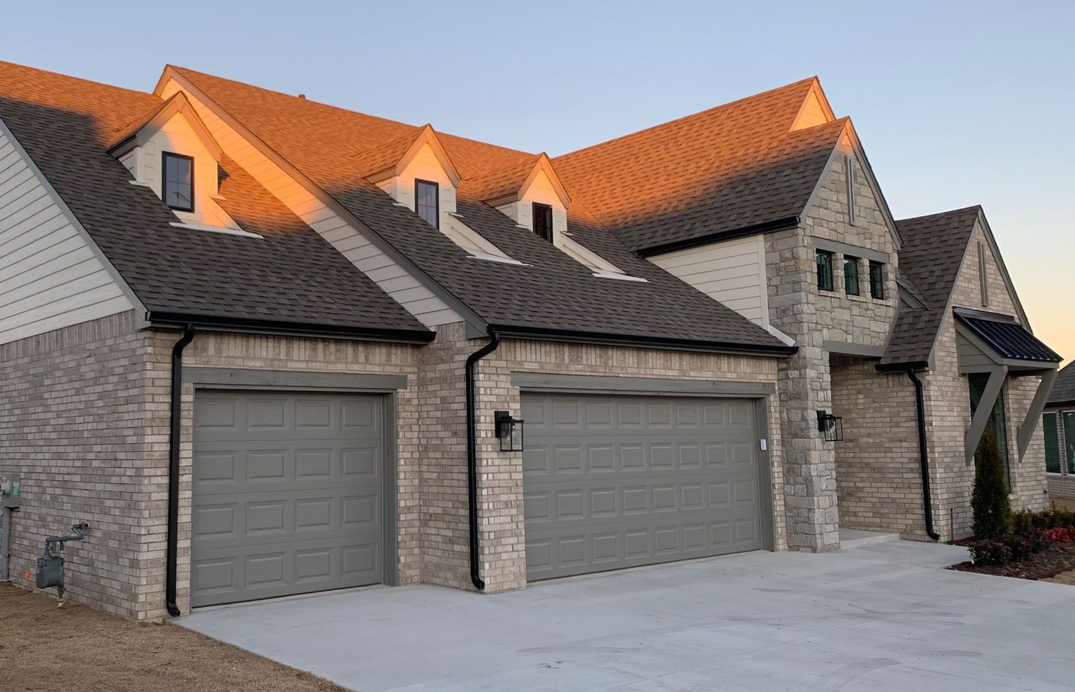 a brick house with a tree in front of it