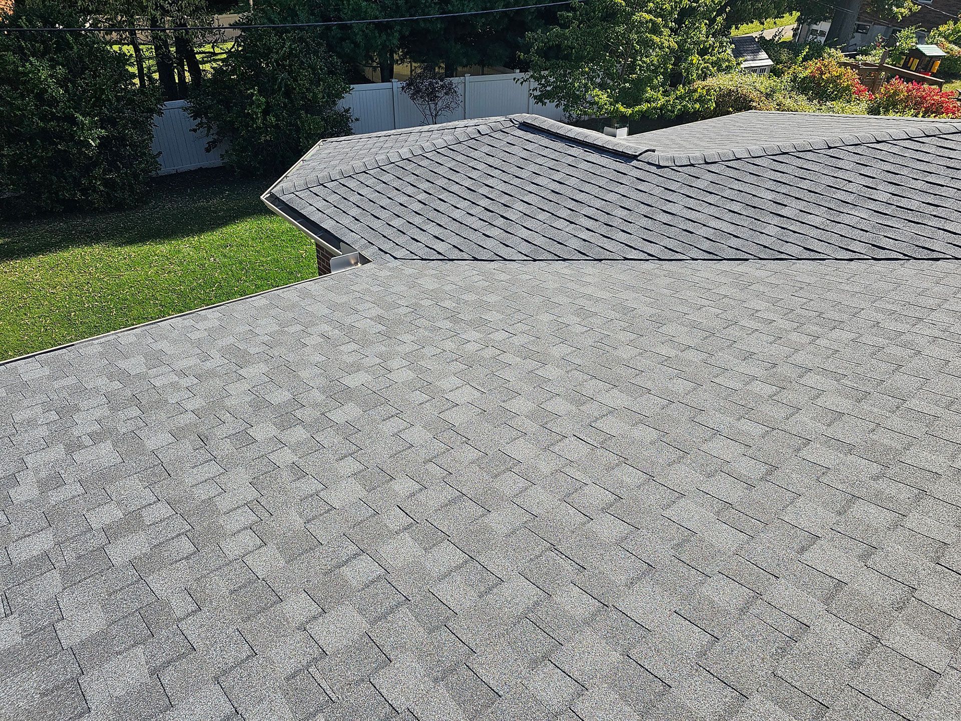 The roof of a house with a gray shingle roof