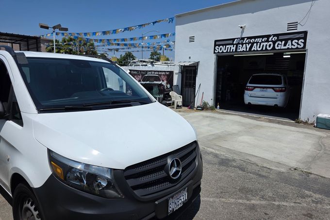 White Mercedes van parked in front of 