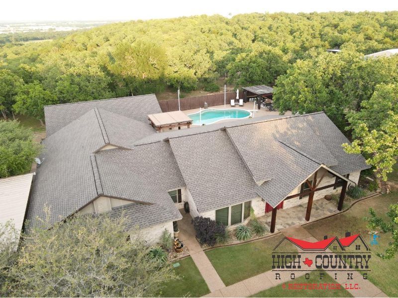 An aerial view of a large house with a pool