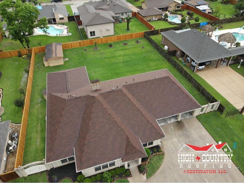 An aerial view of a house with a brown roof