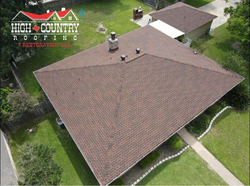 An aerial view of a house with a roof from high country roofing