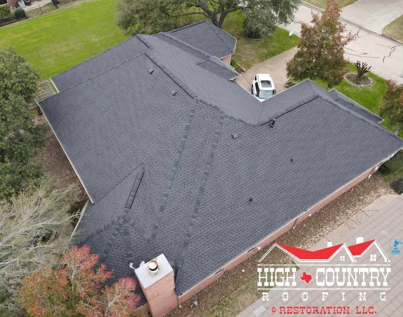 An aerial view of a house with a roof from high country roofing
