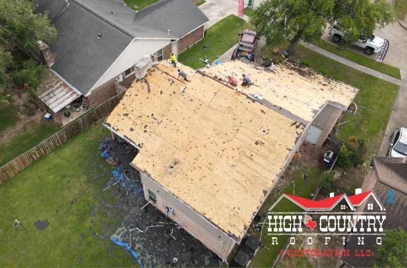 An aerial view of a house being roofed by high country roofing