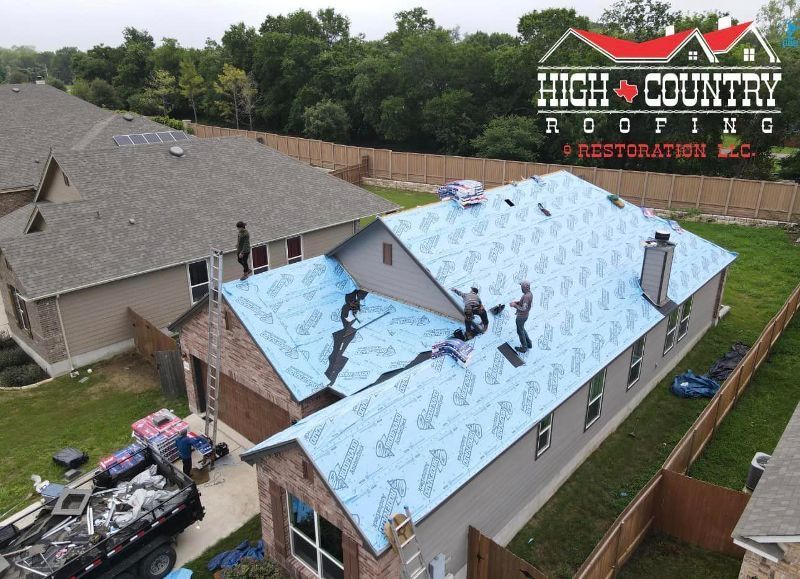 An aerial view of a house being roofed by high country roofing