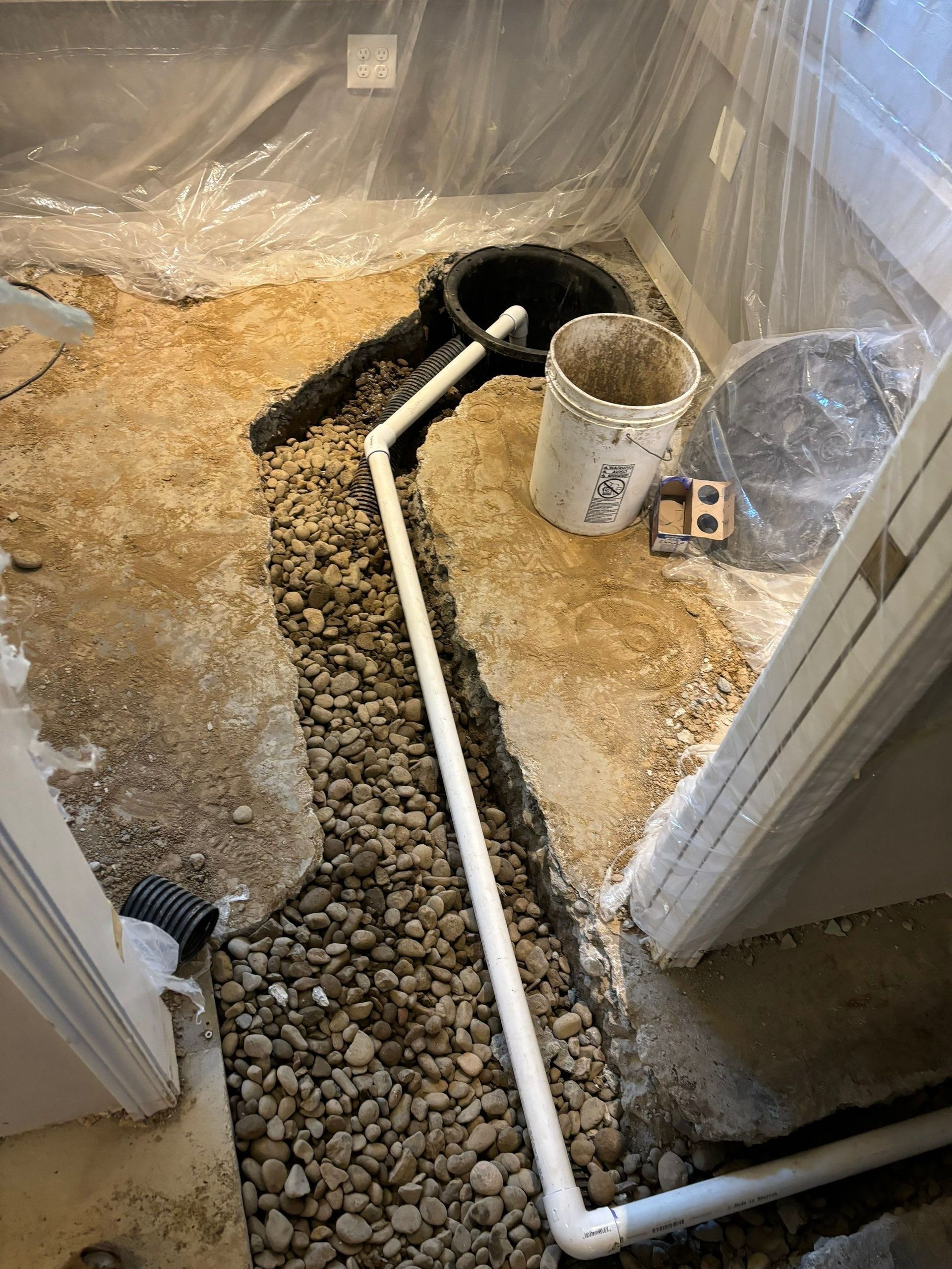 A drain pipe is being installed in a bathroom