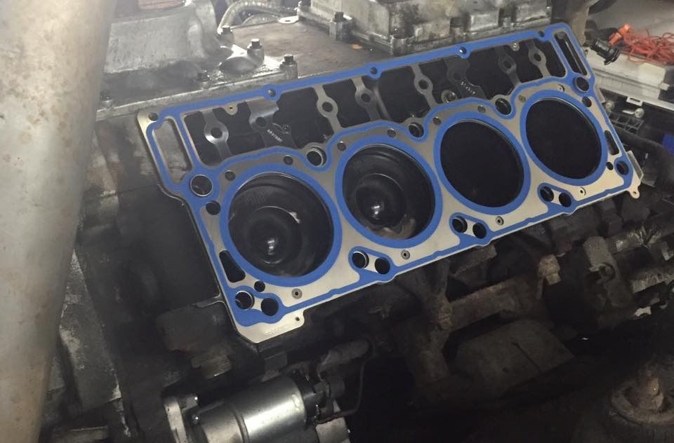 Engine block with blue gasket in place, ready for the cylinder head.