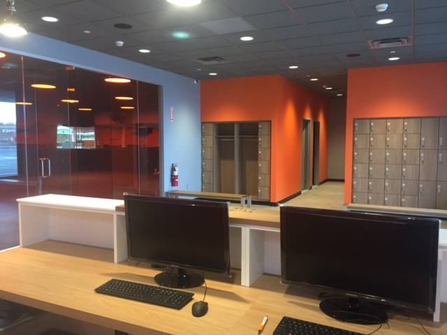 A computer desk with two monitors and a keyboard