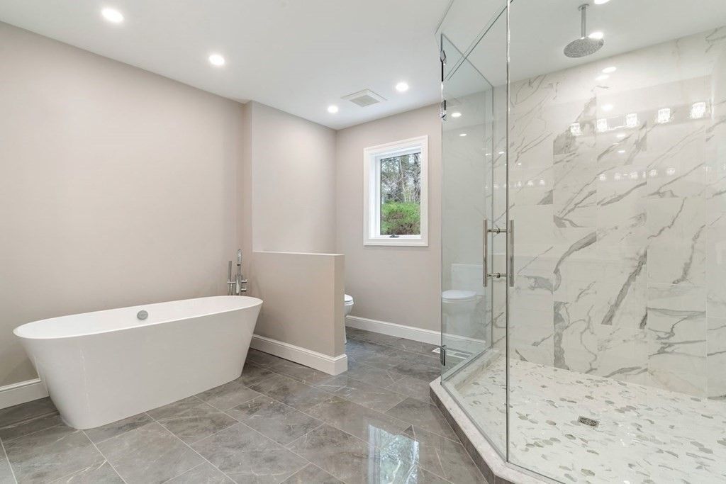 A bathroom with a bathtub and a walk in shower.