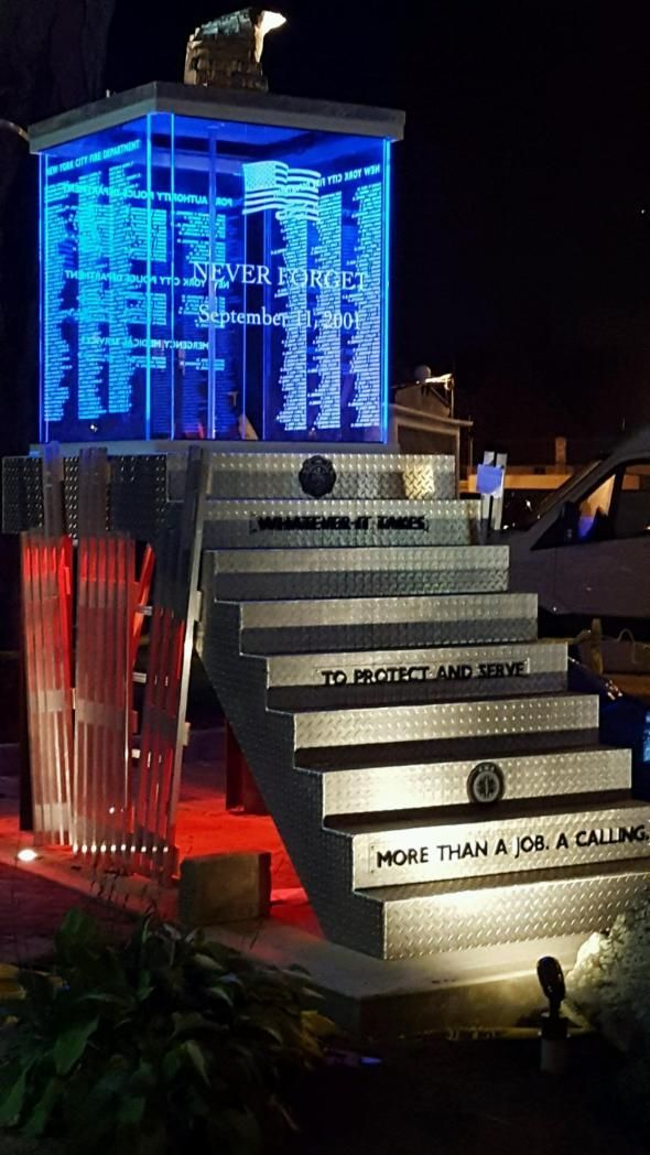 A staircase leading up to a building with a blue light behind it