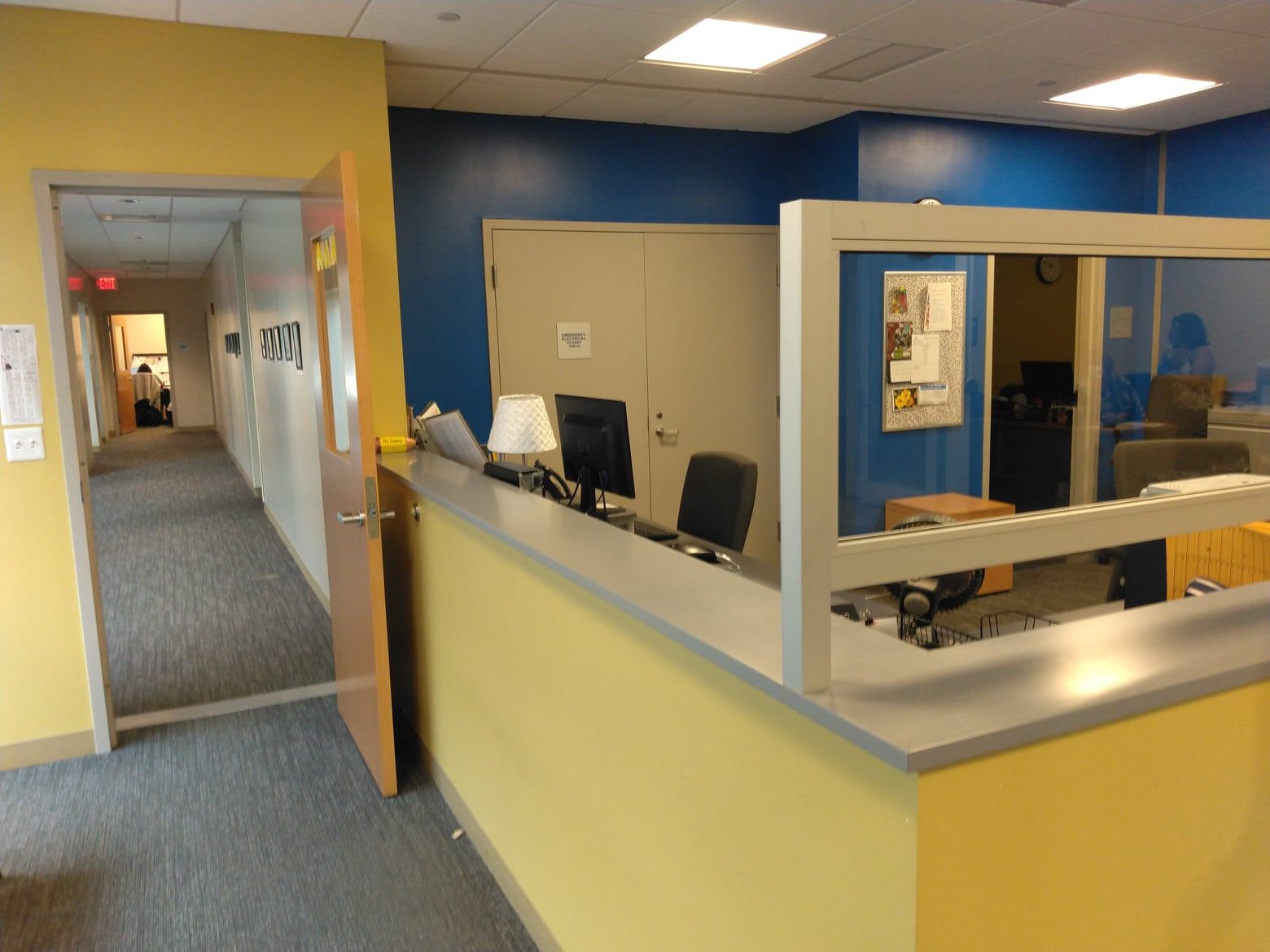A yellow and blue office with a desk and chairs