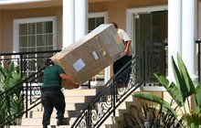 Men moving a large box into a home