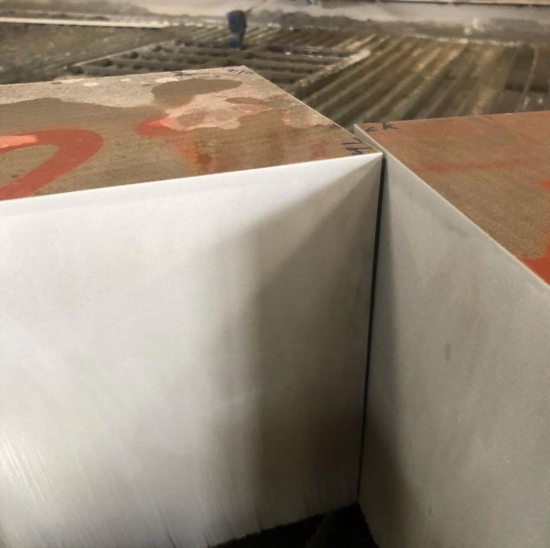 Close-up of two large, white-sided blocks meeting at a corner. Brown tops with red markings.