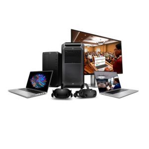 Desktop and laptop computers with headphones and a monitor displaying a conference room scene