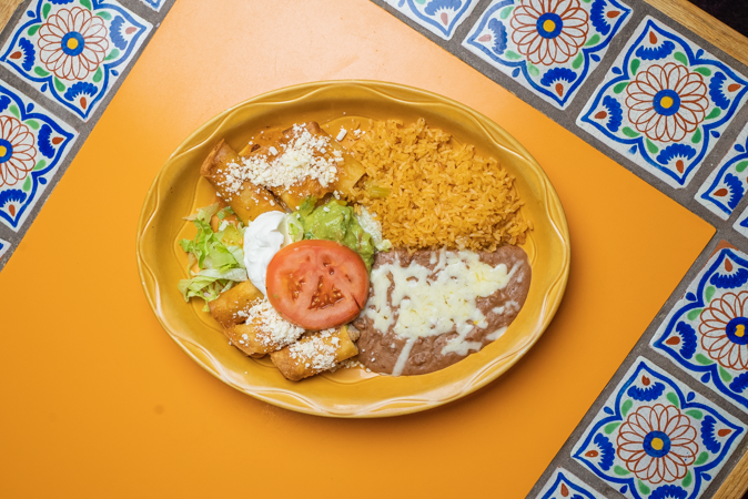 A close up of a plate of mexican food on a table.