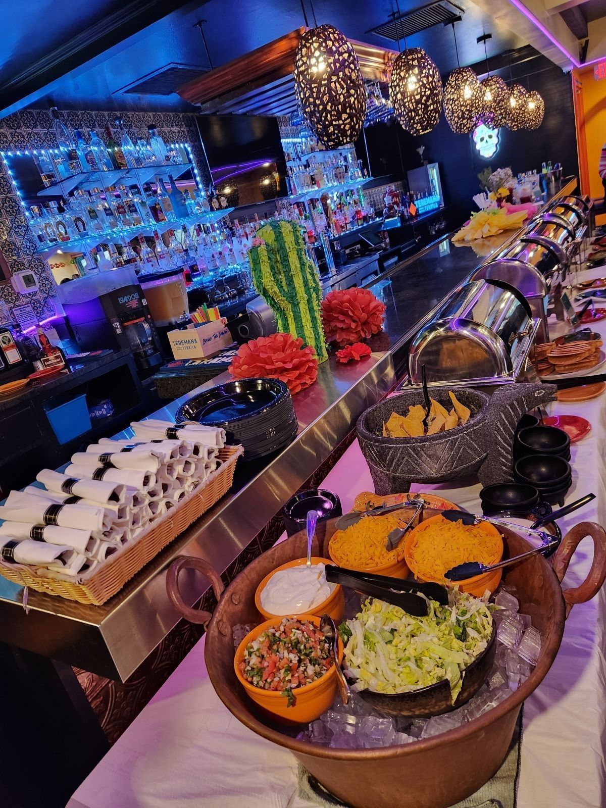 A buffet table with a variety of food on it in a restaurant.