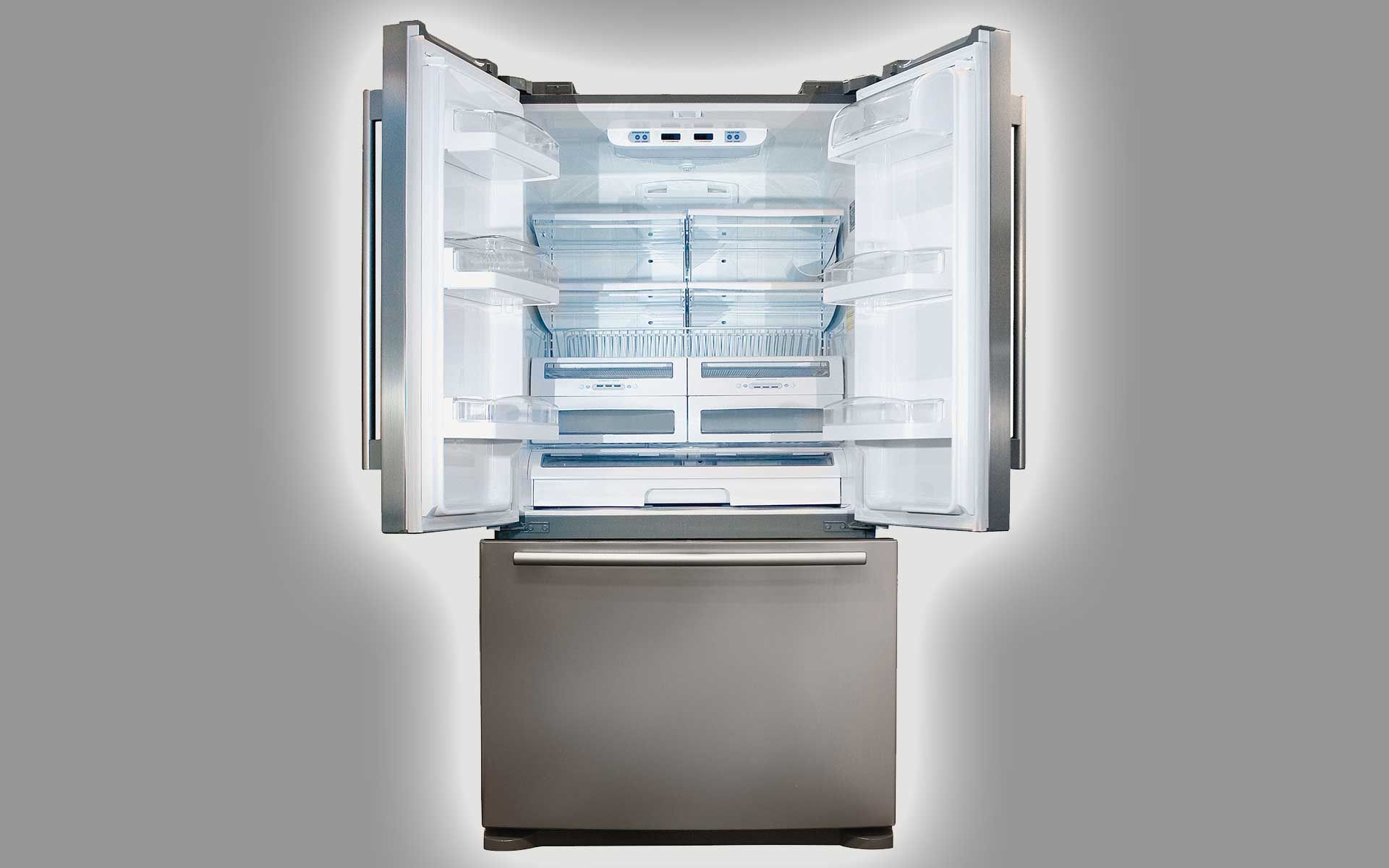 A stainless steel refrigerator with its doors open on a gray background.