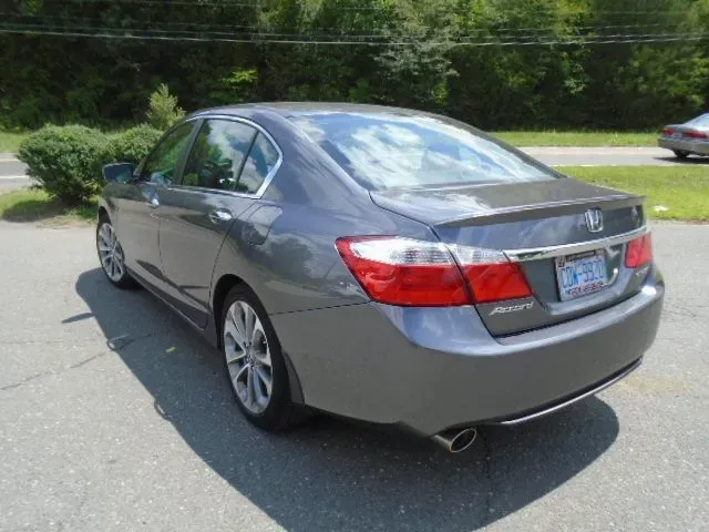 Gray sedan parked on a suburban street, rear three-quarter view.