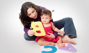 A baby learning letters