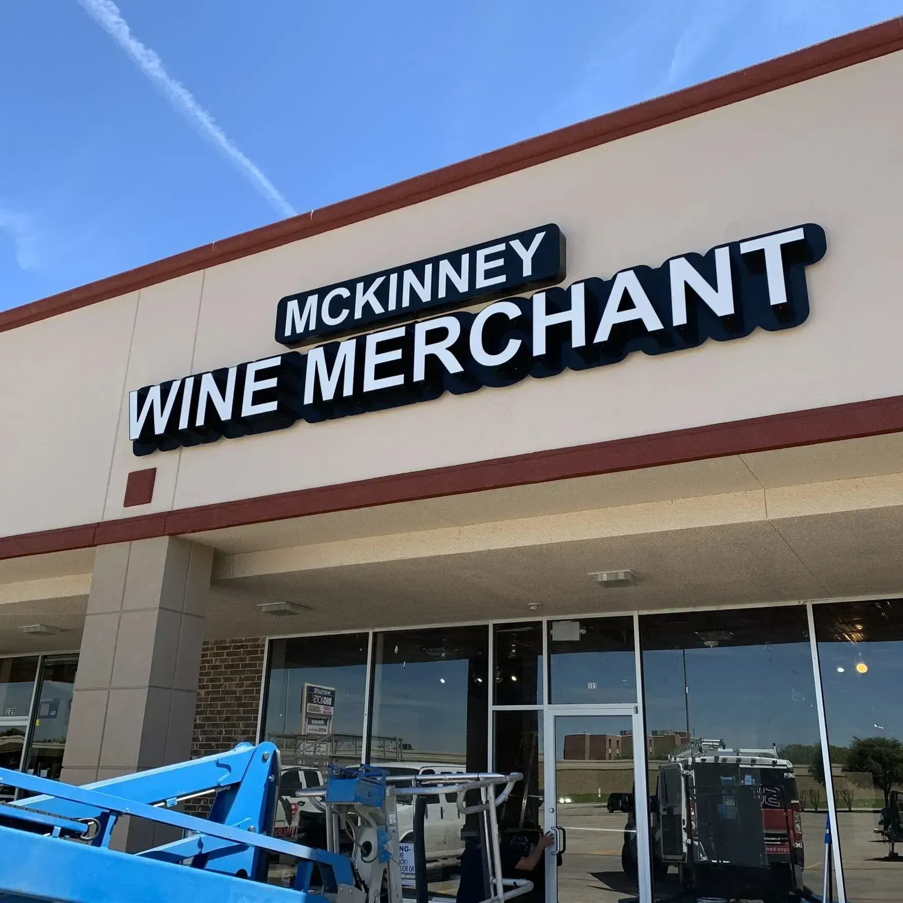 McKinney Wine Merchant storefront with large black-and-white sign above glass entrance