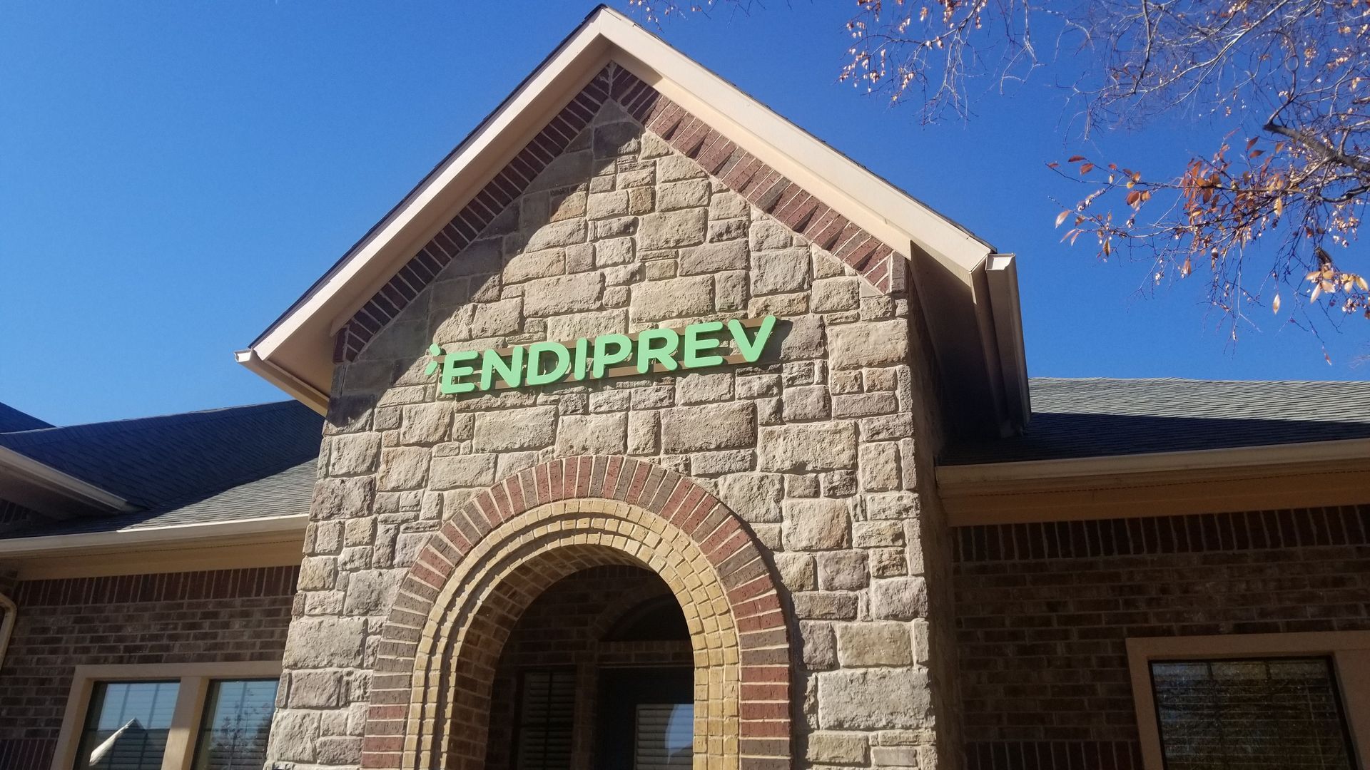 Stone building entrance with green