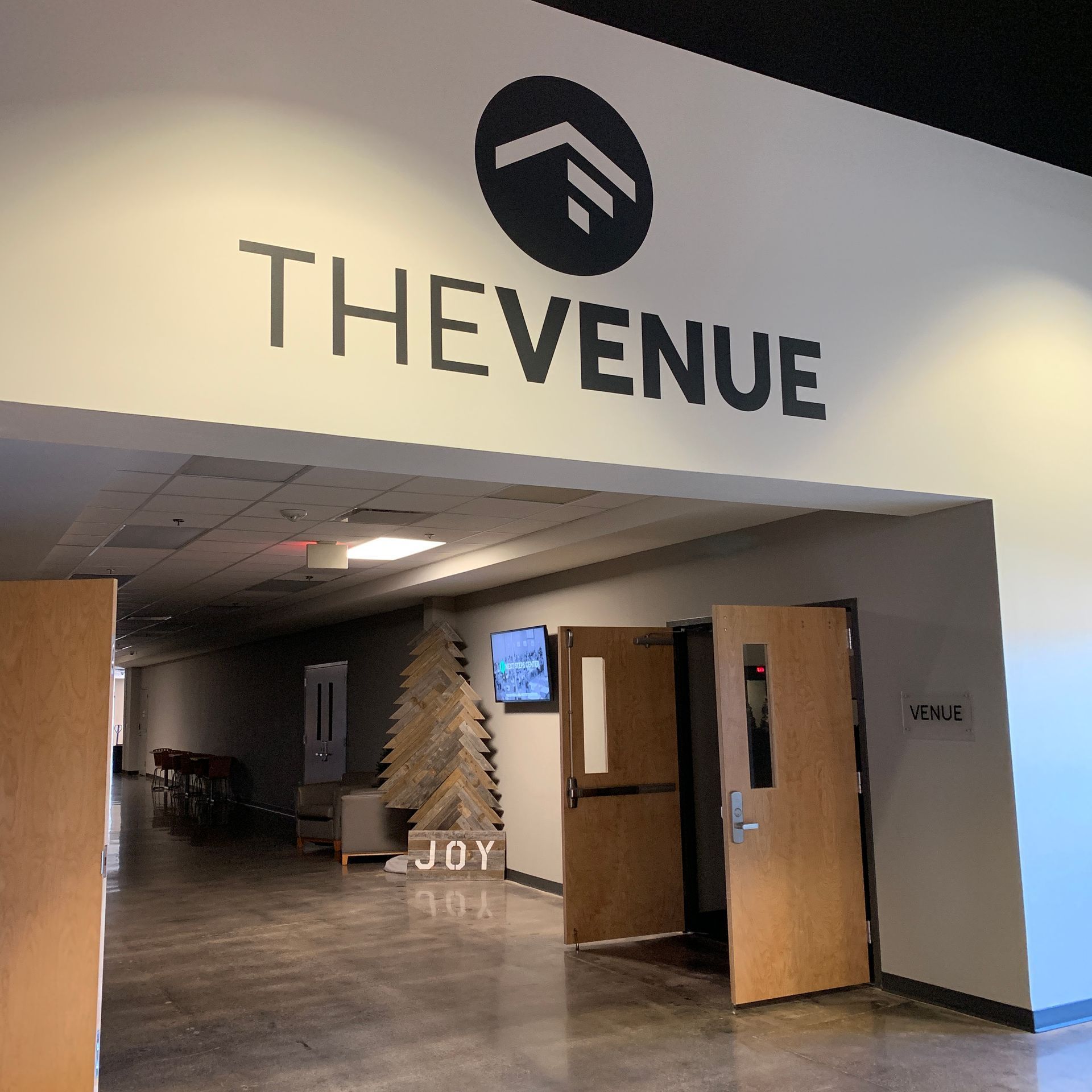 Entrance to The Venue event space with open wooden doors and hallway inside