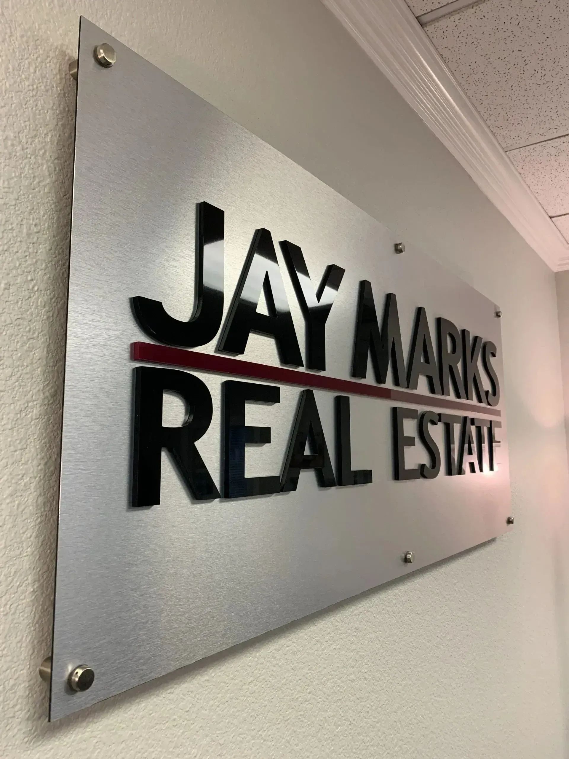 Dimensional acrylic letter wall sign for Jay Marks Real Estate.