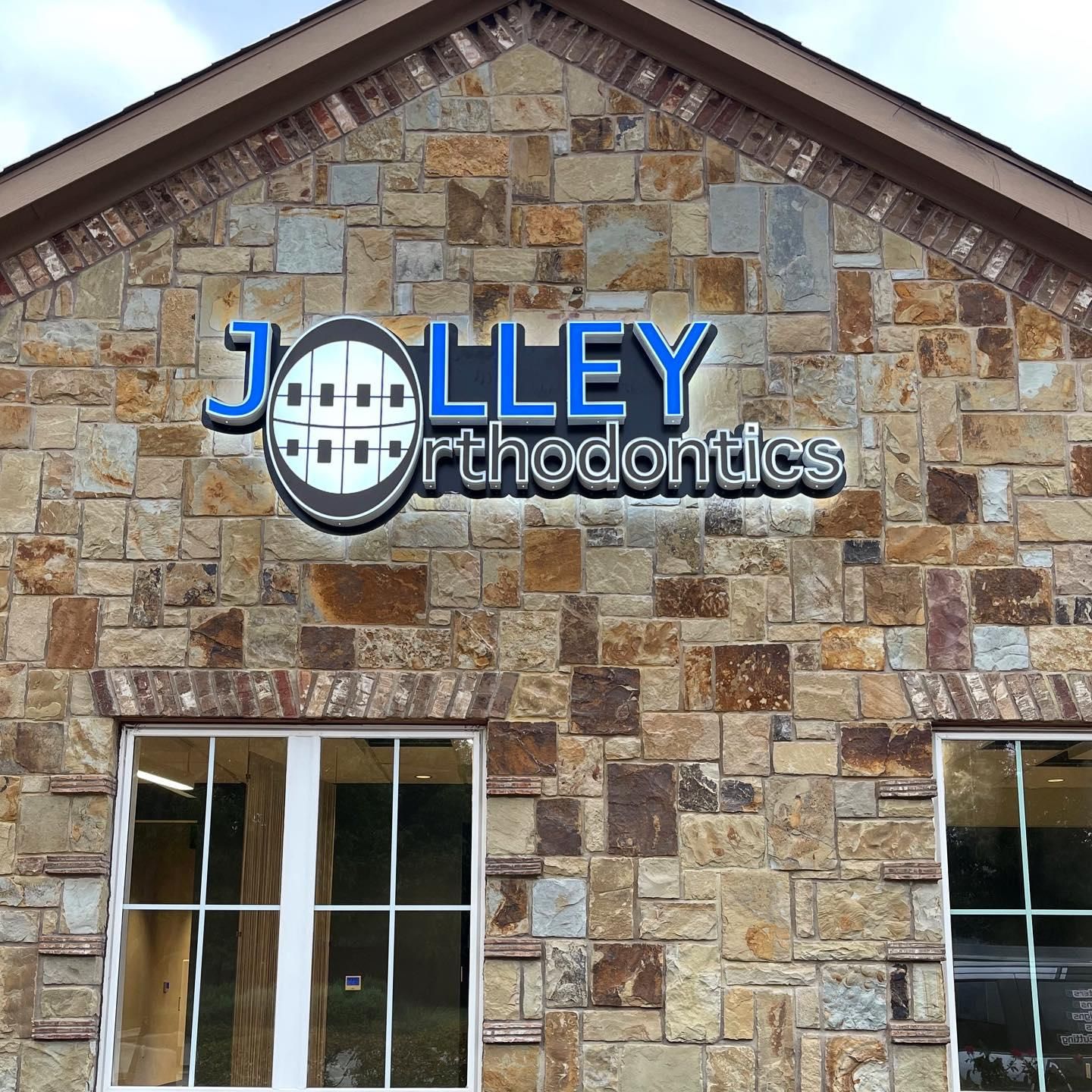 Front-lit channel letter sign on a cloud-cut backer for Jolley Orthodontics in Keller, TX.