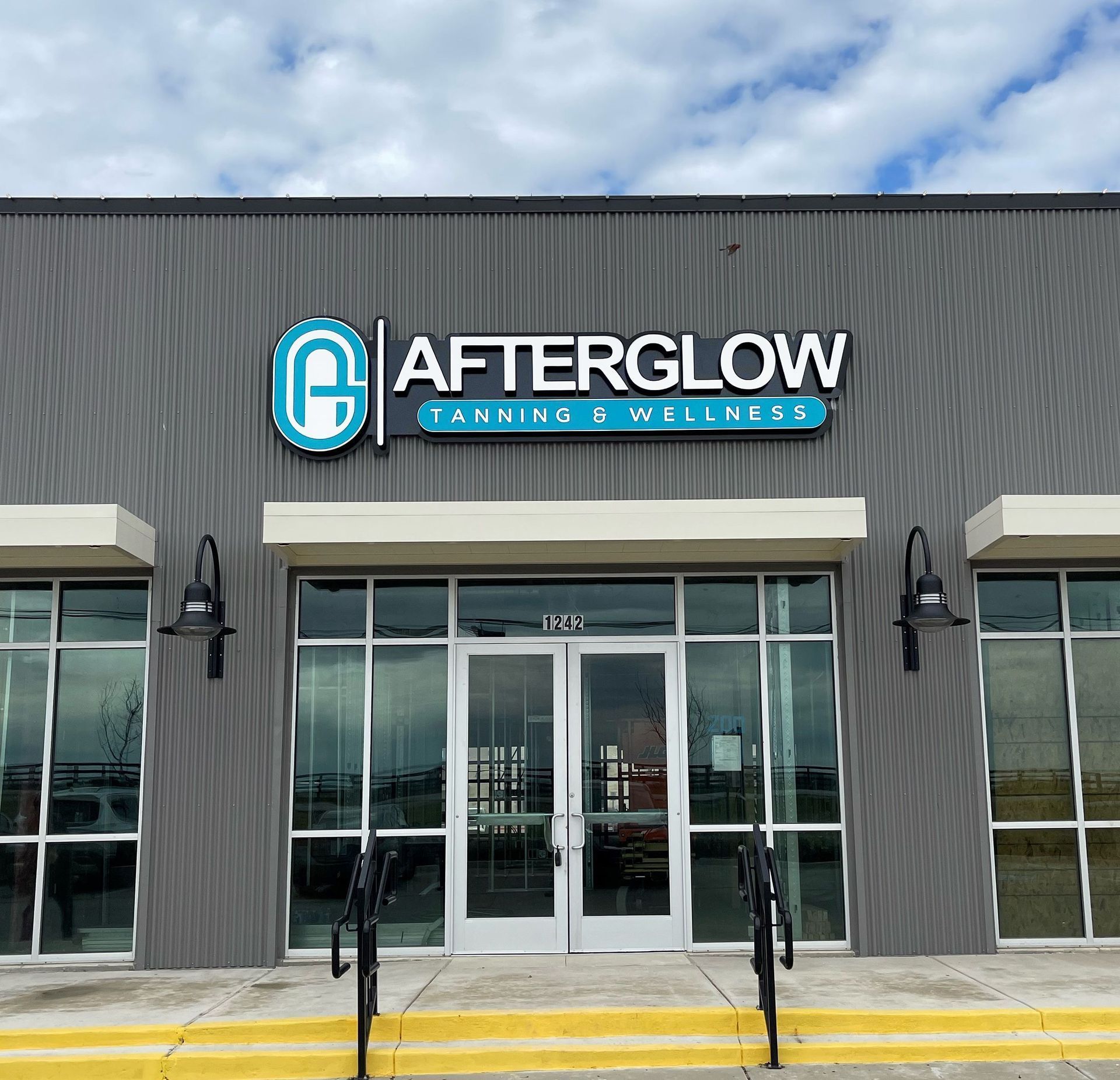 Illuminated channel letter storefront sign for Afterglow Tanning & Wellness in Argyle, TX.