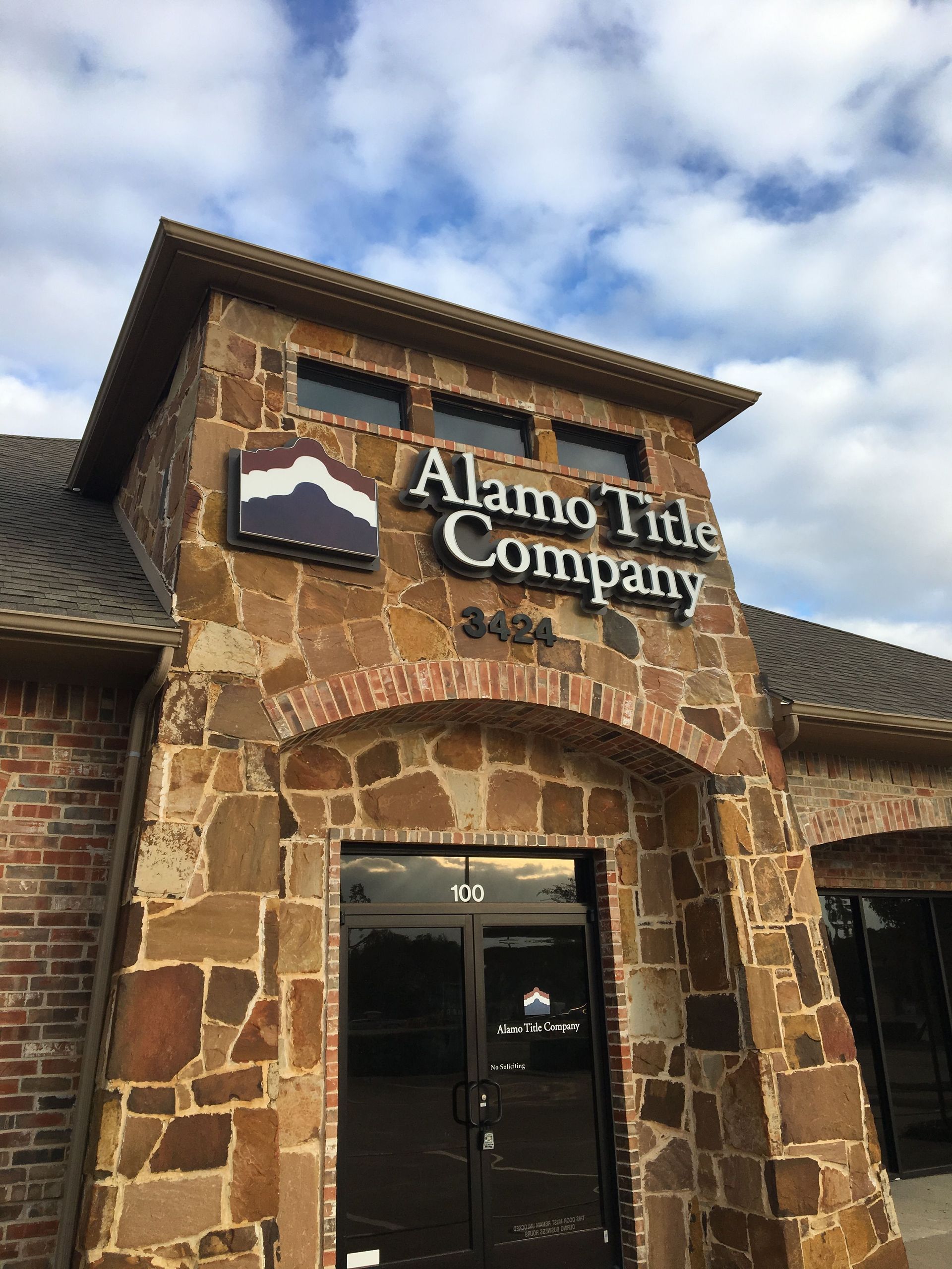 Dimensional letter and logo sign installed for Alamo Title Company above the office entrance.