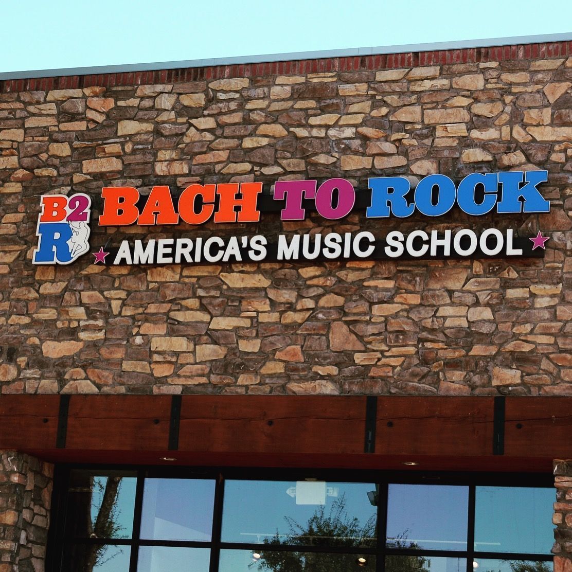 Colorful channel letter storefront sign for Back to Rock America’s Music School.