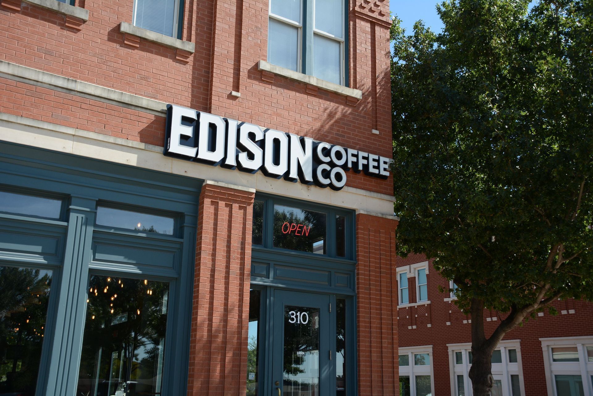 Illuminated channel letter storefront sign for Edison Coffee Co. in Lewisville, TX.