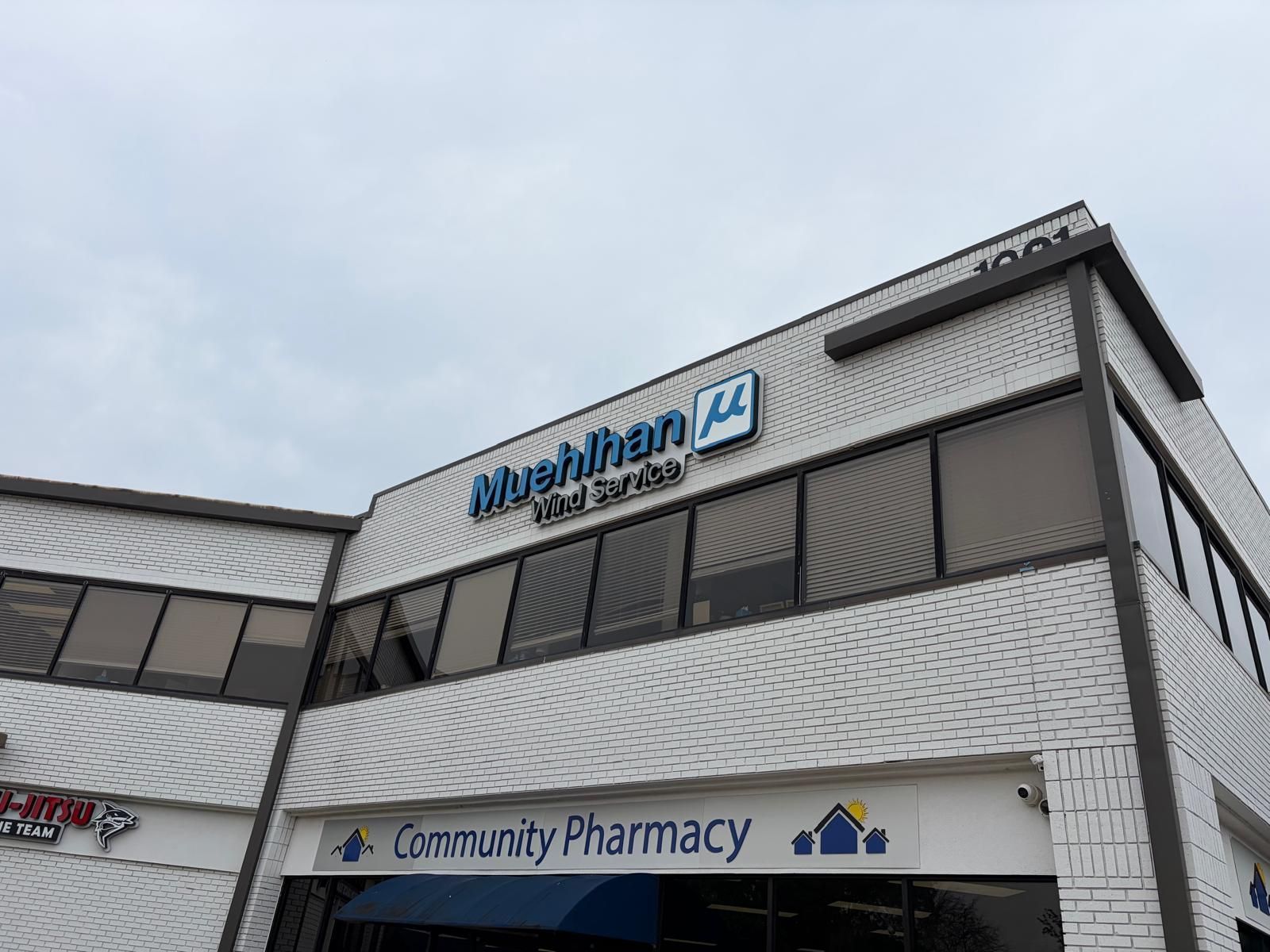 Exterior building sign with dimensional lettering and logo for Muehlhan Wind Service in Flower Mound, TX.