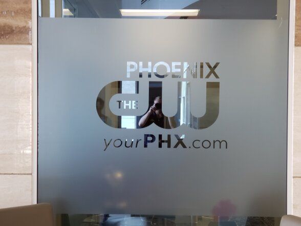 a glass wall with a Phoenix logo on it