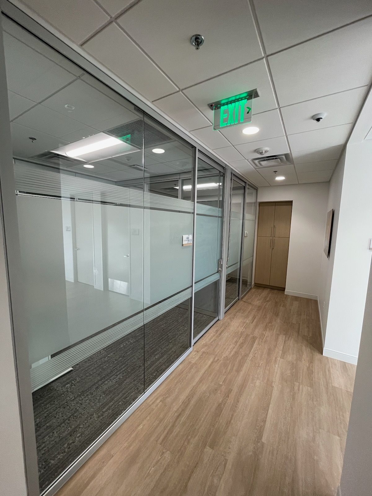 an office space with frosted glass wall and door