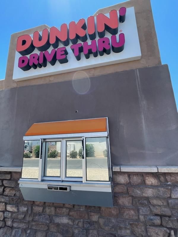 a Dunkin' Donuts drive thru with a tinted window