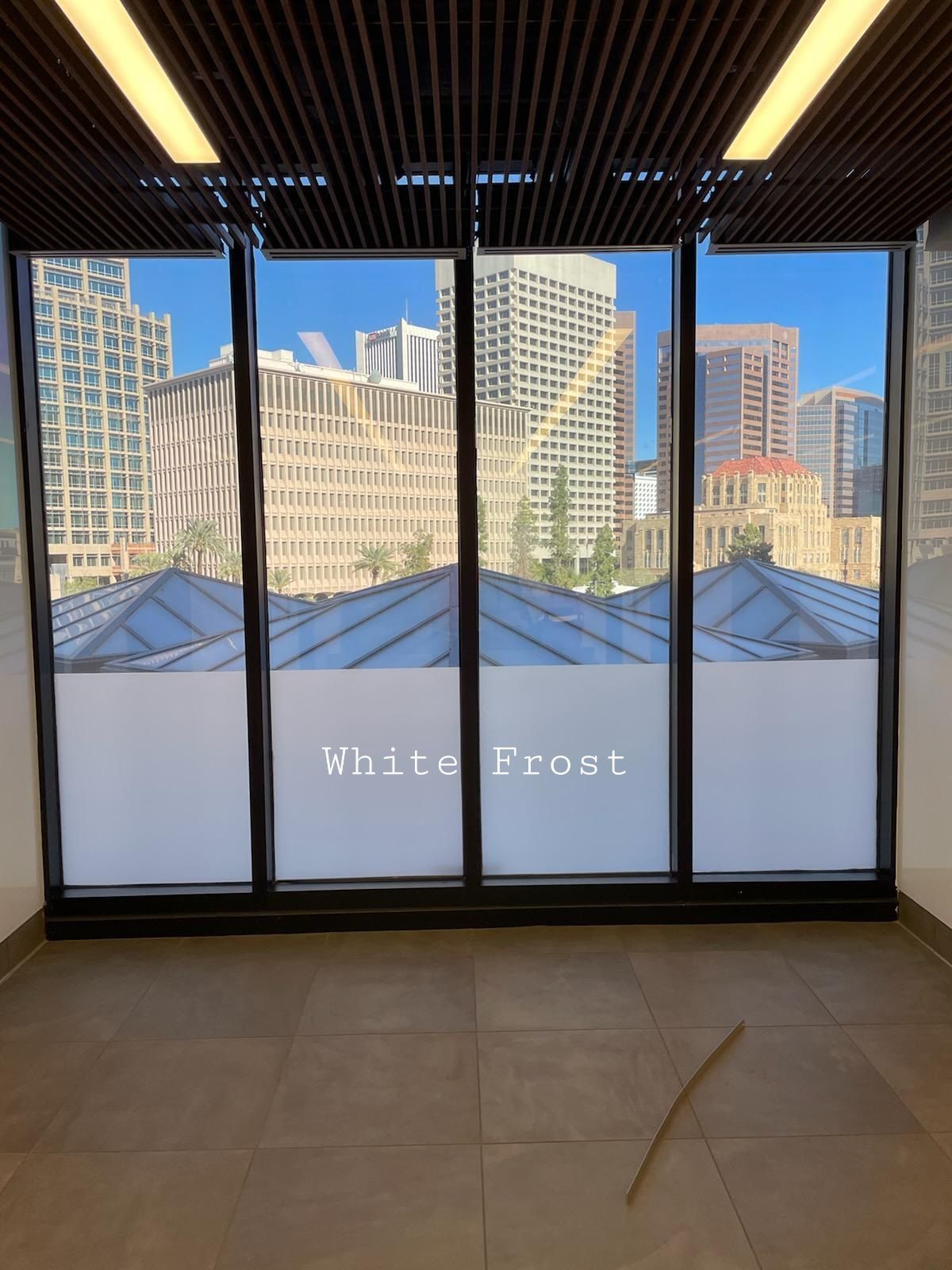 a white frost window with a view of the city
